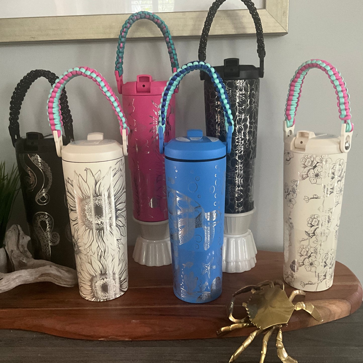 Assorted 24 oz flip straw tumblers with paracord handles