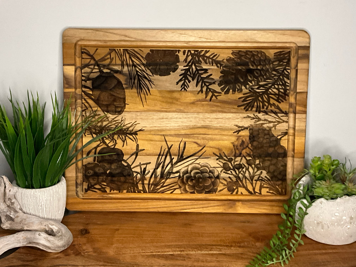 Teak board with pinecone border